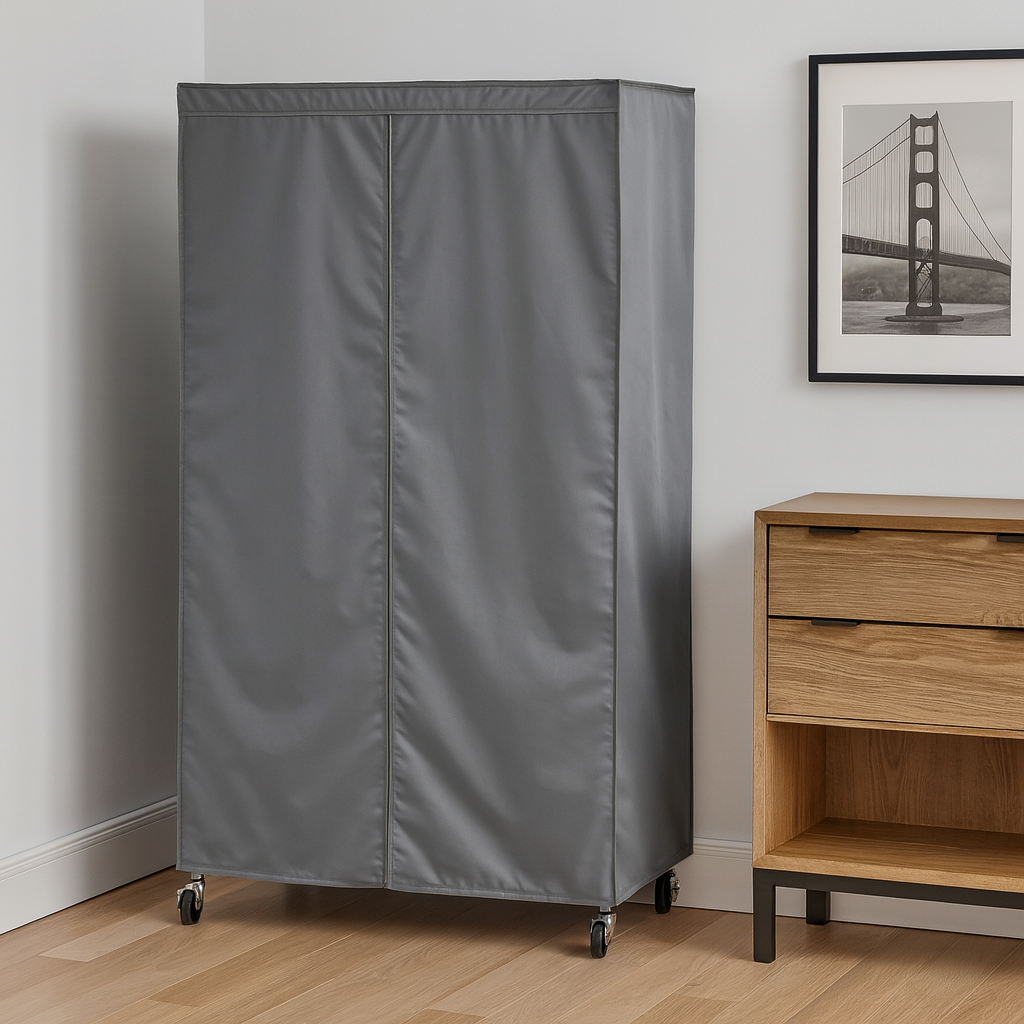 Gray fabric-covered cabinet on wheels next to a wooden dresser with a framed picture on the wall.

